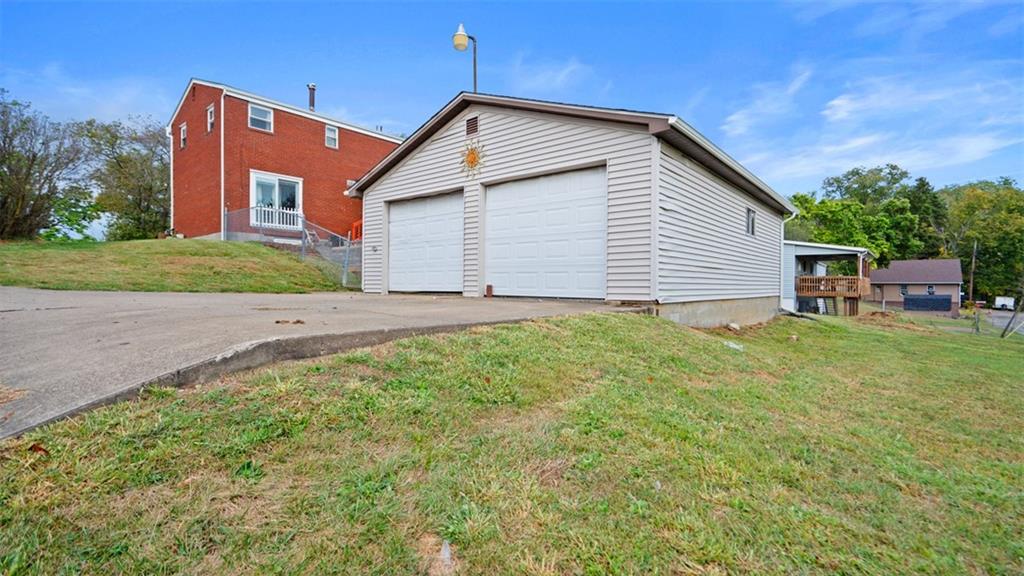300 Sunset Boulevard Washington, PA 15301 - Photo 33 of 38 a backyard of a house with plants and large tree