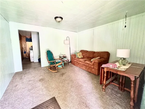 a living room with furniture a flat screen tv and a table