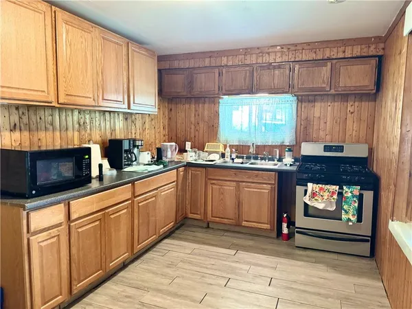 a kitchen with stainless steel appliances a stove a sink and a microwave