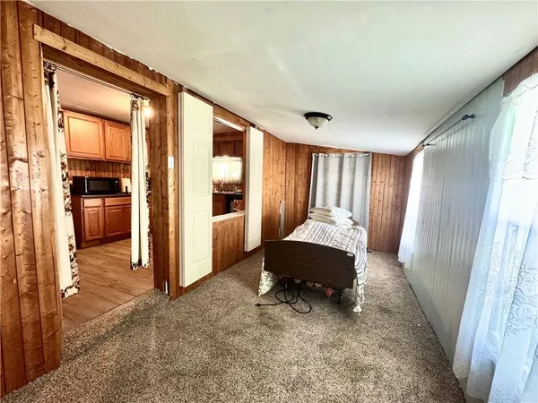 a living room with a couch and a refrigerator