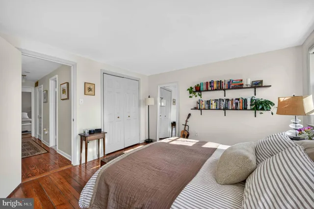 a bedroom with a bed and a book shelf