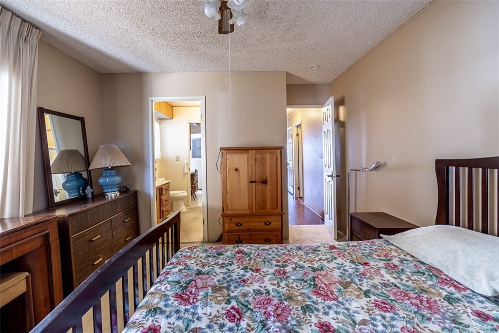 24600 Mountain Avenue, Unit 57 Hemet, CA 92544 - Photo 11 of 20 a bedroom with a bed and a dresser in it