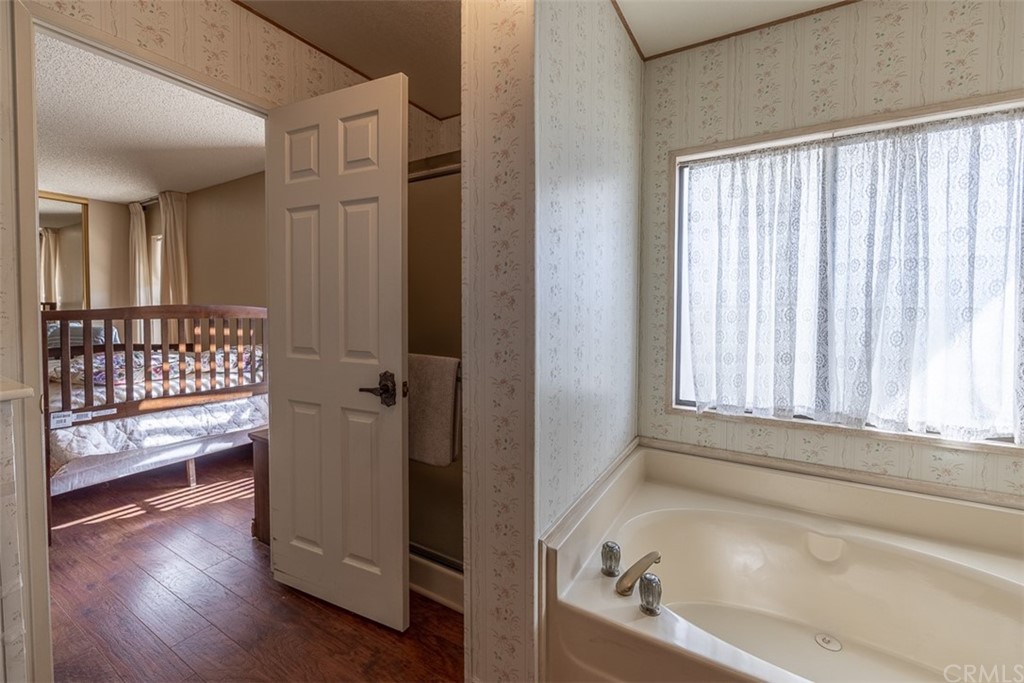 24600 Mountain Avenue, Unit 57 Hemet, CA 92544 - Photo 14 of 20 a bathroom with a bathtub and a window