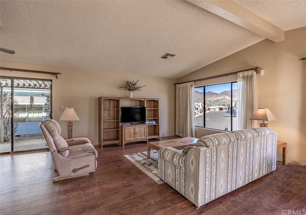 24600 Mountain Avenue, Unit 57 Hemet, CA 92544 - Photo 3 of 20 a living room with furniture and a flat screen tv