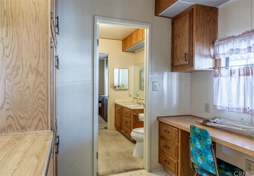 24600 Mountain Avenue, Unit 57 Hemet, CA 92544 - Photo 8 of 20 a kitchen with cabinets and a stove