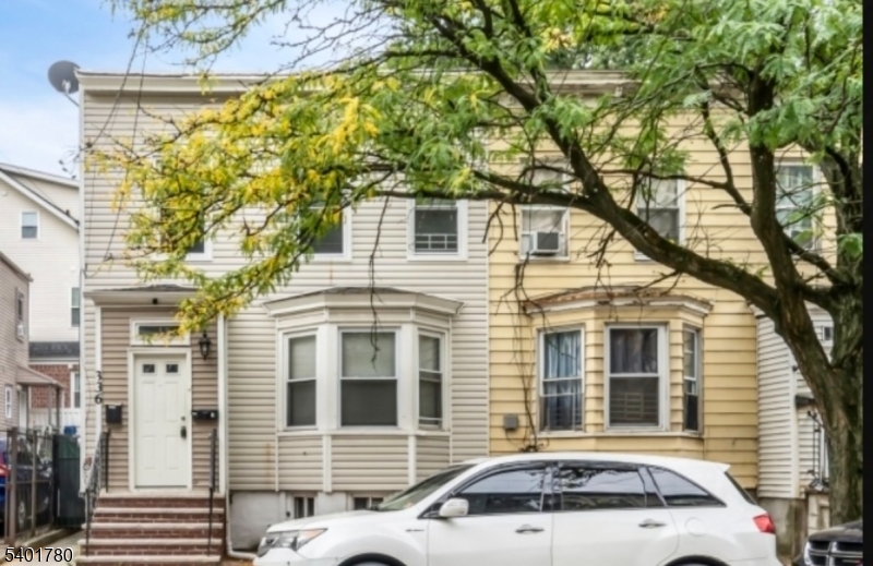a view of a car park in front of a house