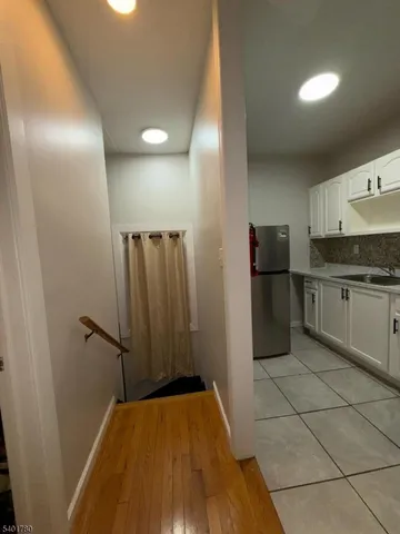 a kitchen with granite countertop a stove and a refrigerator