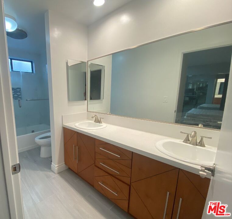 1940 North Highland Avenue, Unit 44 Los Angeles, CA 90068 - Photo 8 of 10 a bathroom with a double vanity sink toilet and shower