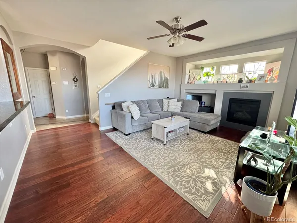 a living room with furniture and a flat screen tv with wooden floor