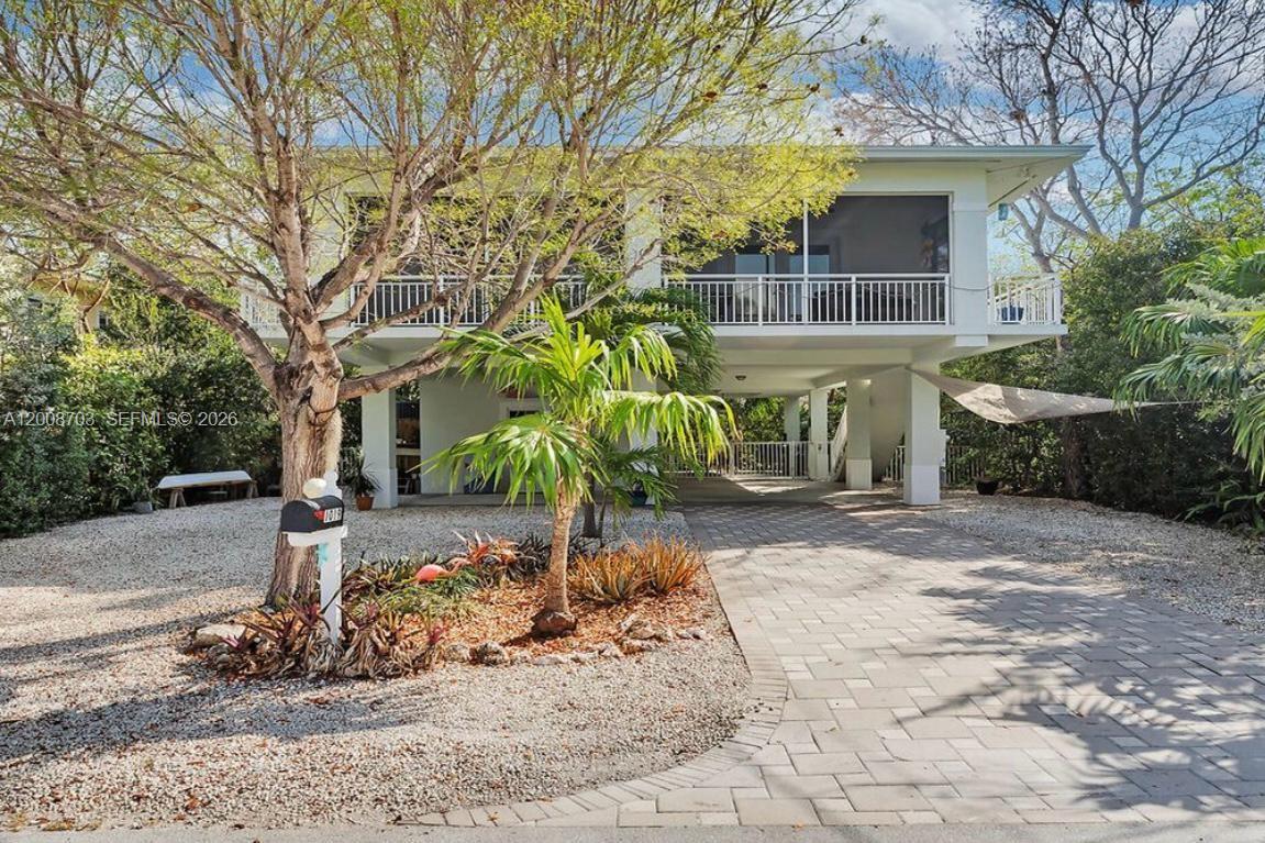 1019 Snapper Lane Key Largo, FL 33037 - Photo 1 of 37 a view of a house with a yard covered with snow