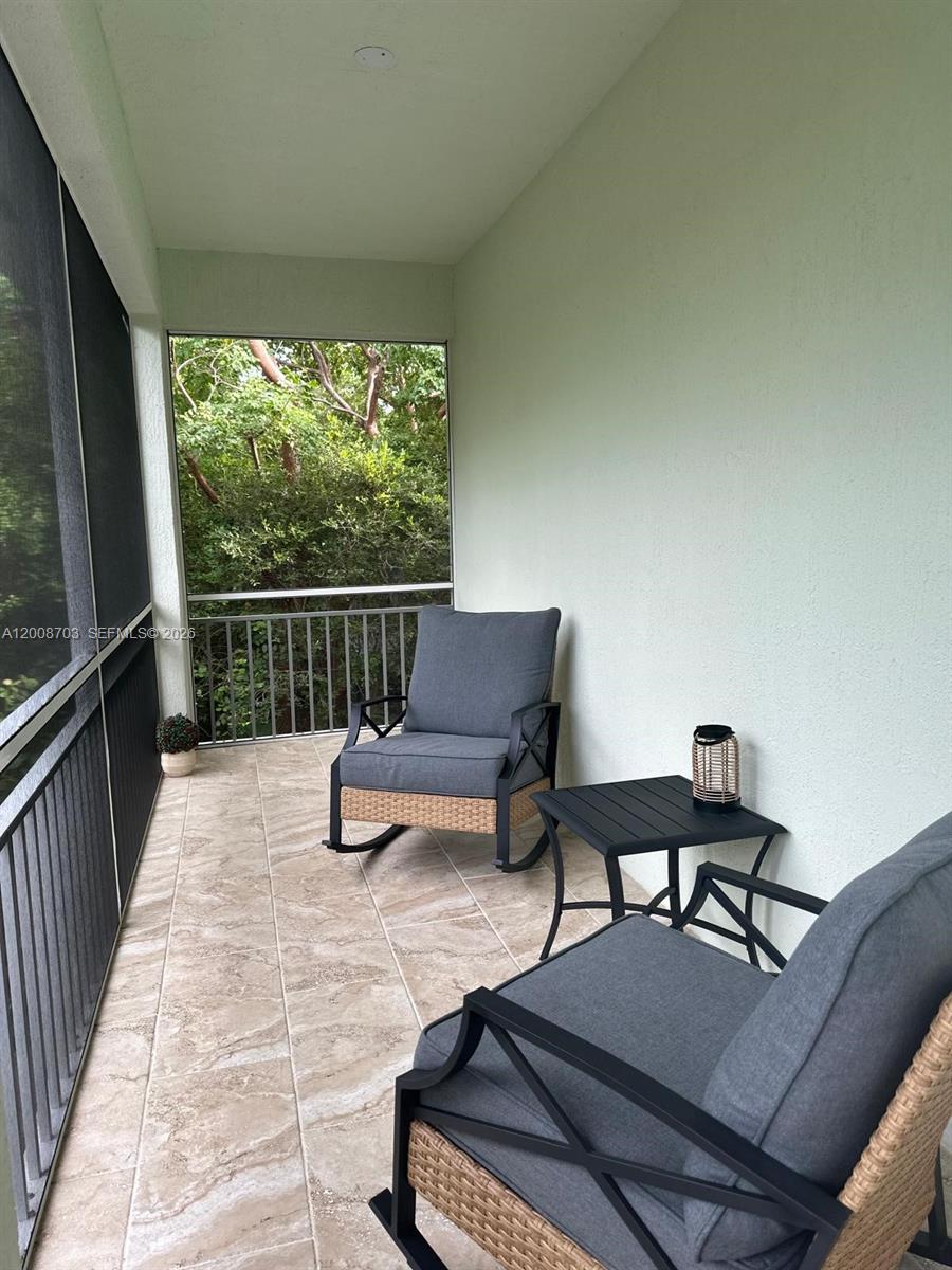 1019 Snapper Lane Key Largo, FL 33037 - Photo 11 of 37 a view of a chairs and tables in the balcony