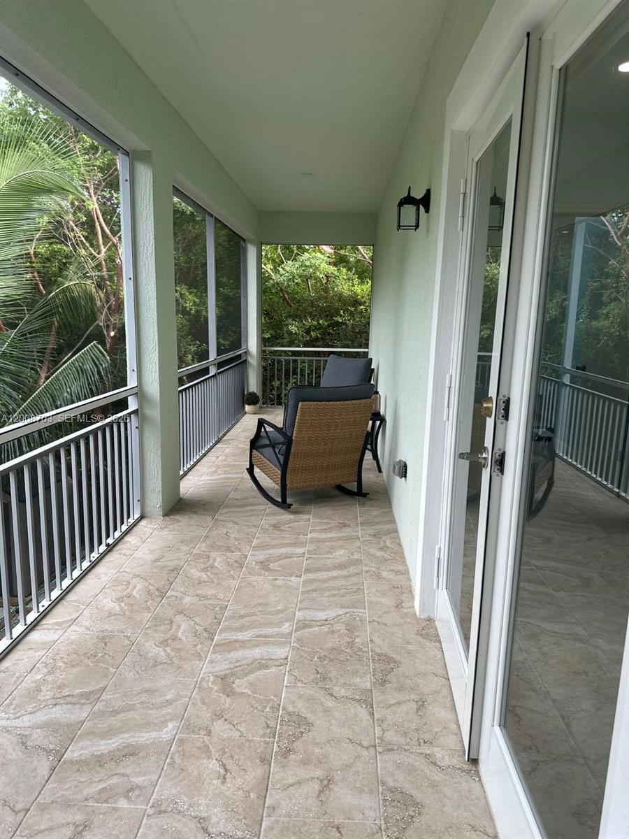 1019 Snapper Lane Key Largo, FL 33037 - Photo 13 of 37 a balcony with couch in front of it