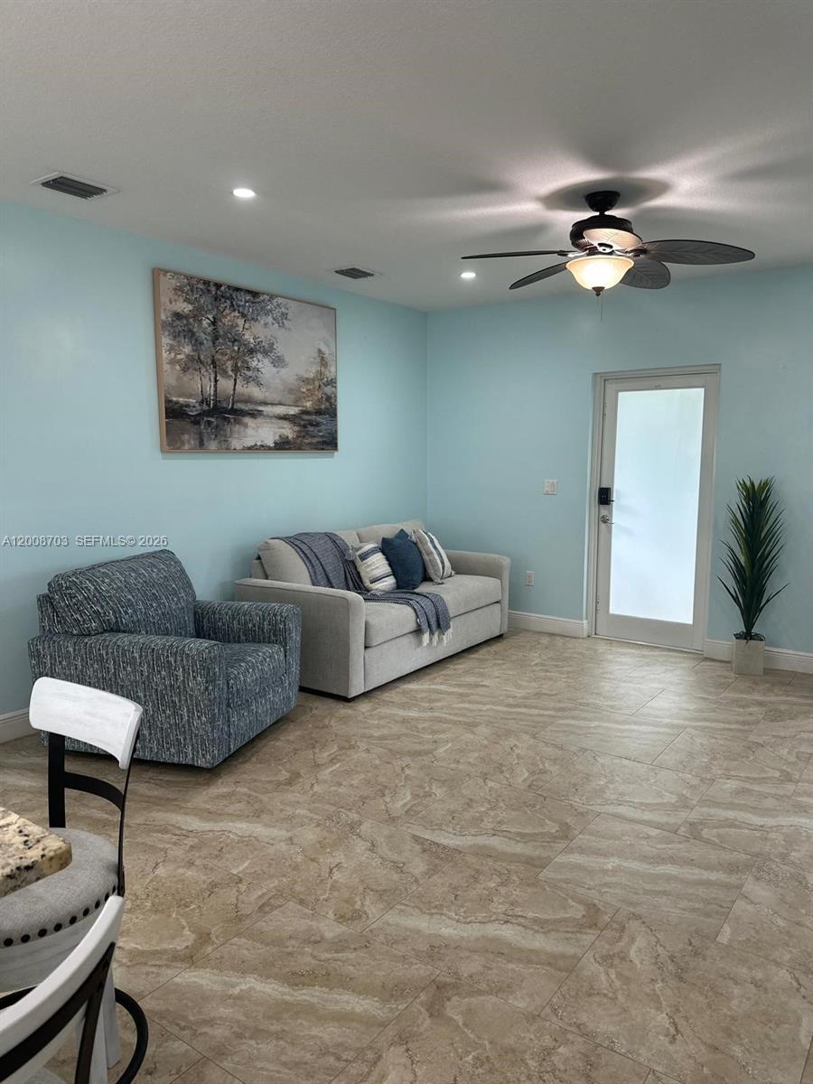 1019 Snapper Lane Key Largo, FL 33037 - Photo 16 of 37 a living room with furniture and a ceiling fan