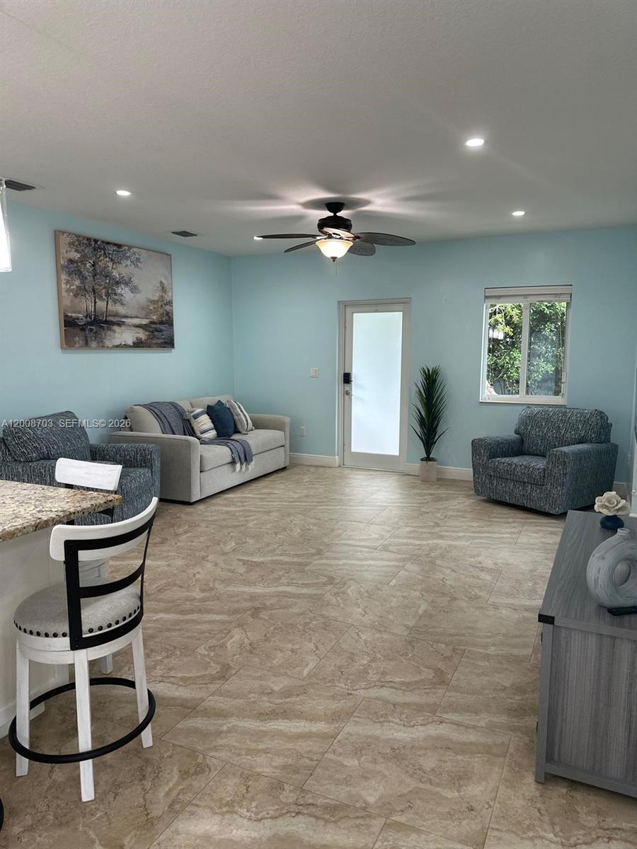 1019 Snapper Lane Key Largo, FL 33037 - Photo 18 of 37 a living room with furniture and a chandelier
