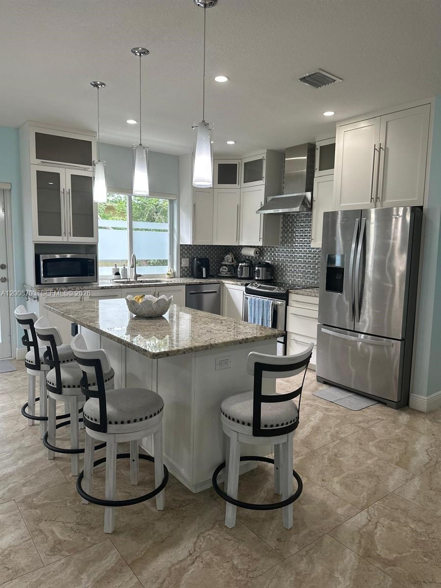 1019 Snapper Lane Key Largo, FL 33037 - Photo 19 of 37 a kitchen with sink refrigerator and microwave
