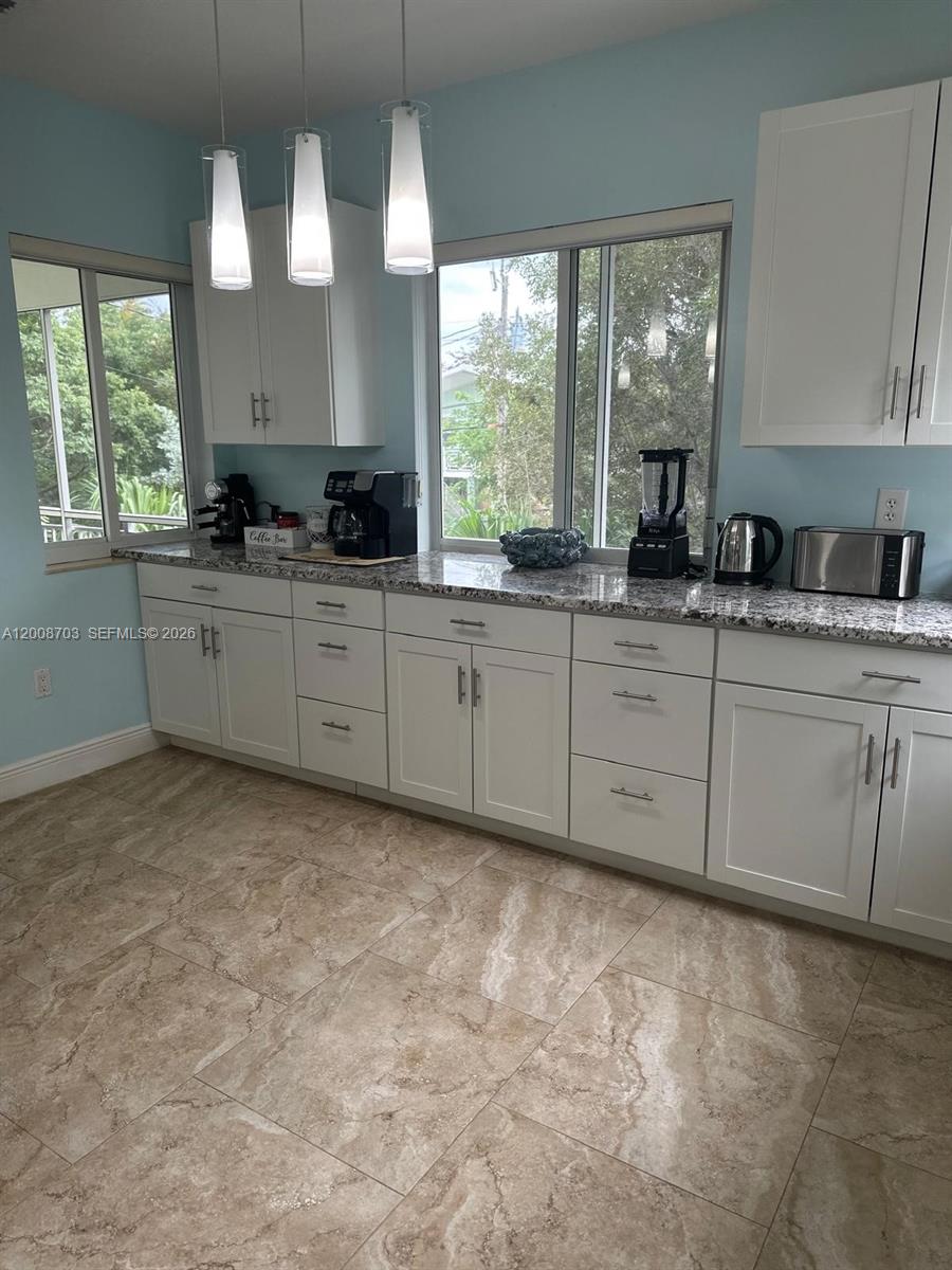 1019 Snapper Lane Key Largo, FL 33037 - Photo 20 of 37 a large white cabinets with kitchen island granite countertop a sink window and cabinets