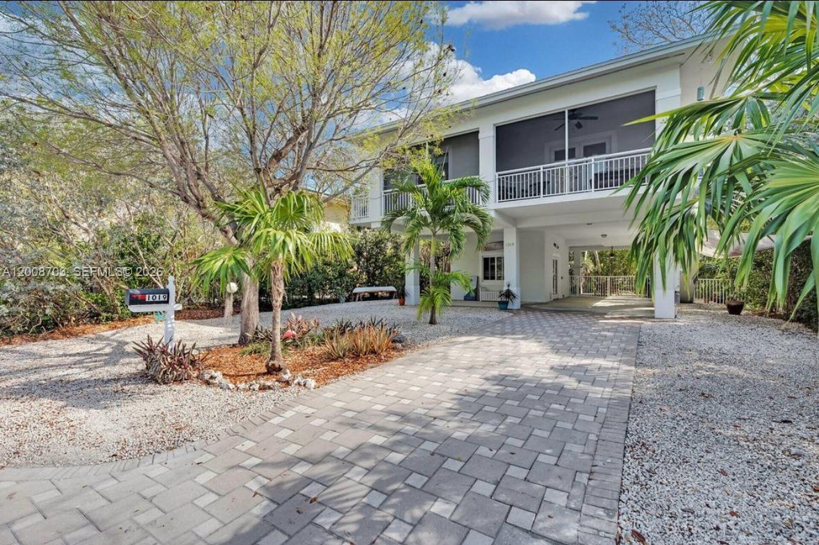 1019 Snapper Lane Key Largo, FL 33037 - Photo 2 of 37 a view of a yard with plants and trees