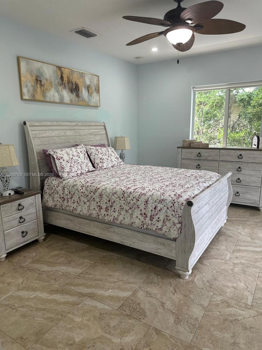 1019 Snapper Lane Key Largo, FL 33037 - Photo 24 of 37 a bedroom with a bed and a window