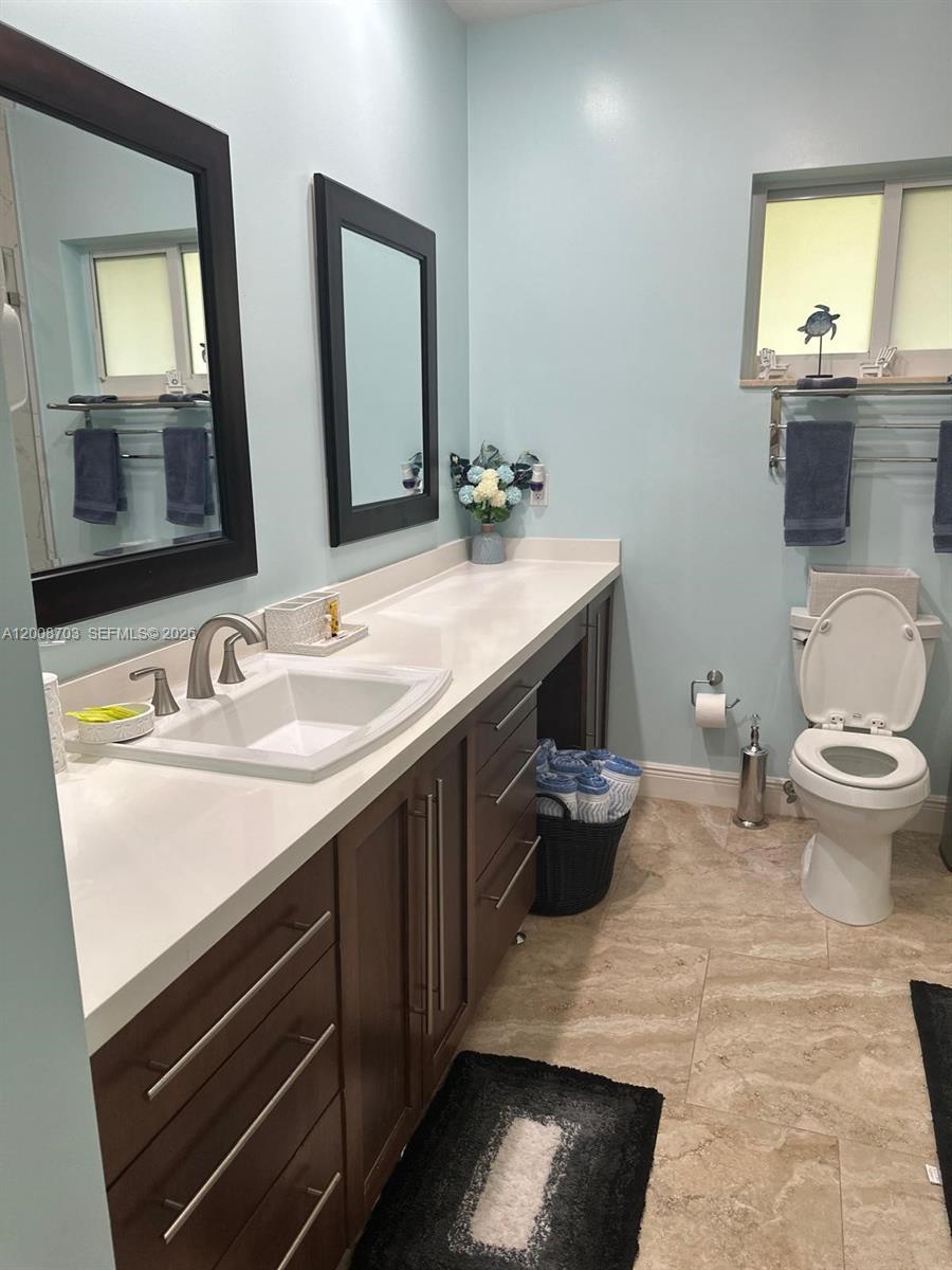1019 Snapper Lane Key Largo, FL 33037 - Photo 26 of 37 a bathroom with a granite countertop toilet sink and mirror