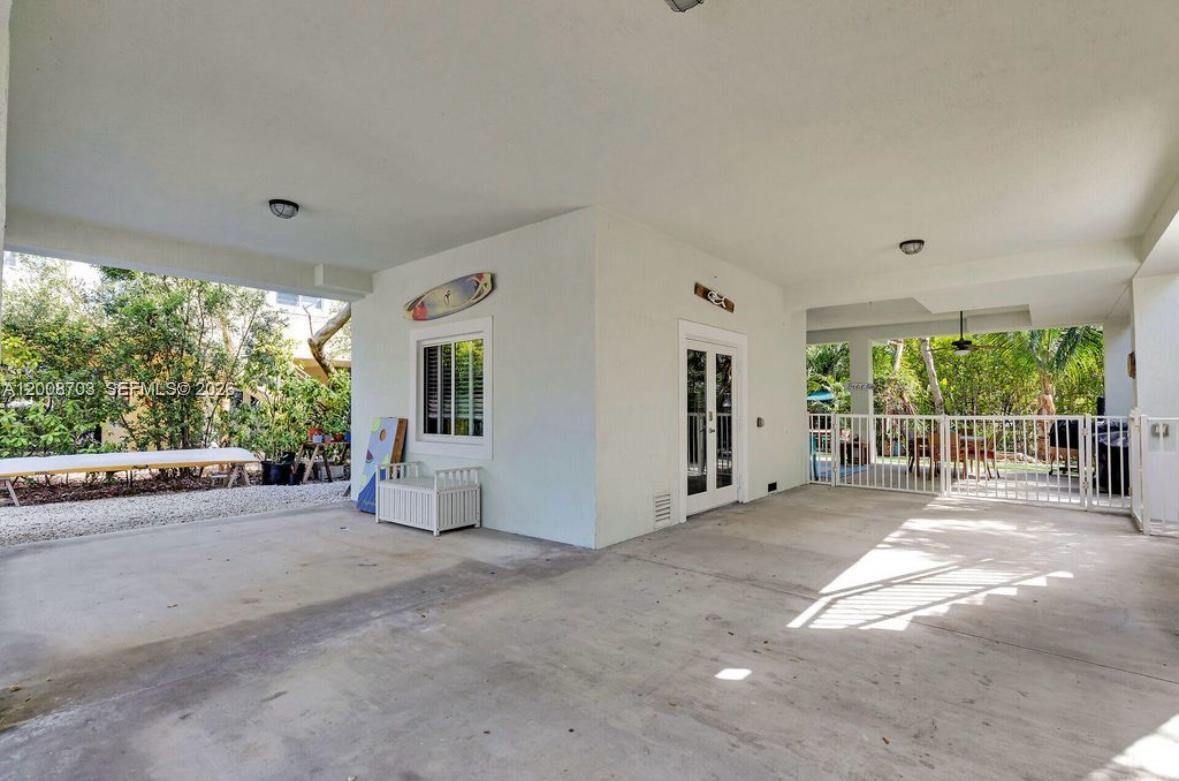 1019 Snapper Lane Key Largo, FL 33037 - Photo 3 of 37 a view of a house with porch and garden