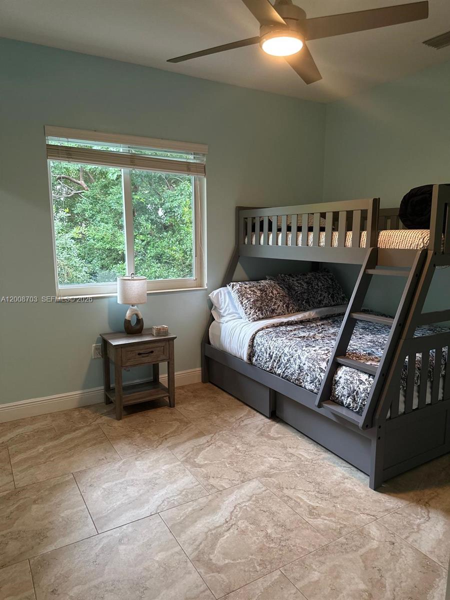 1019 Snapper Lane Key Largo, FL 33037 - Photo 32 of 37 a bedroom with a bed and a window