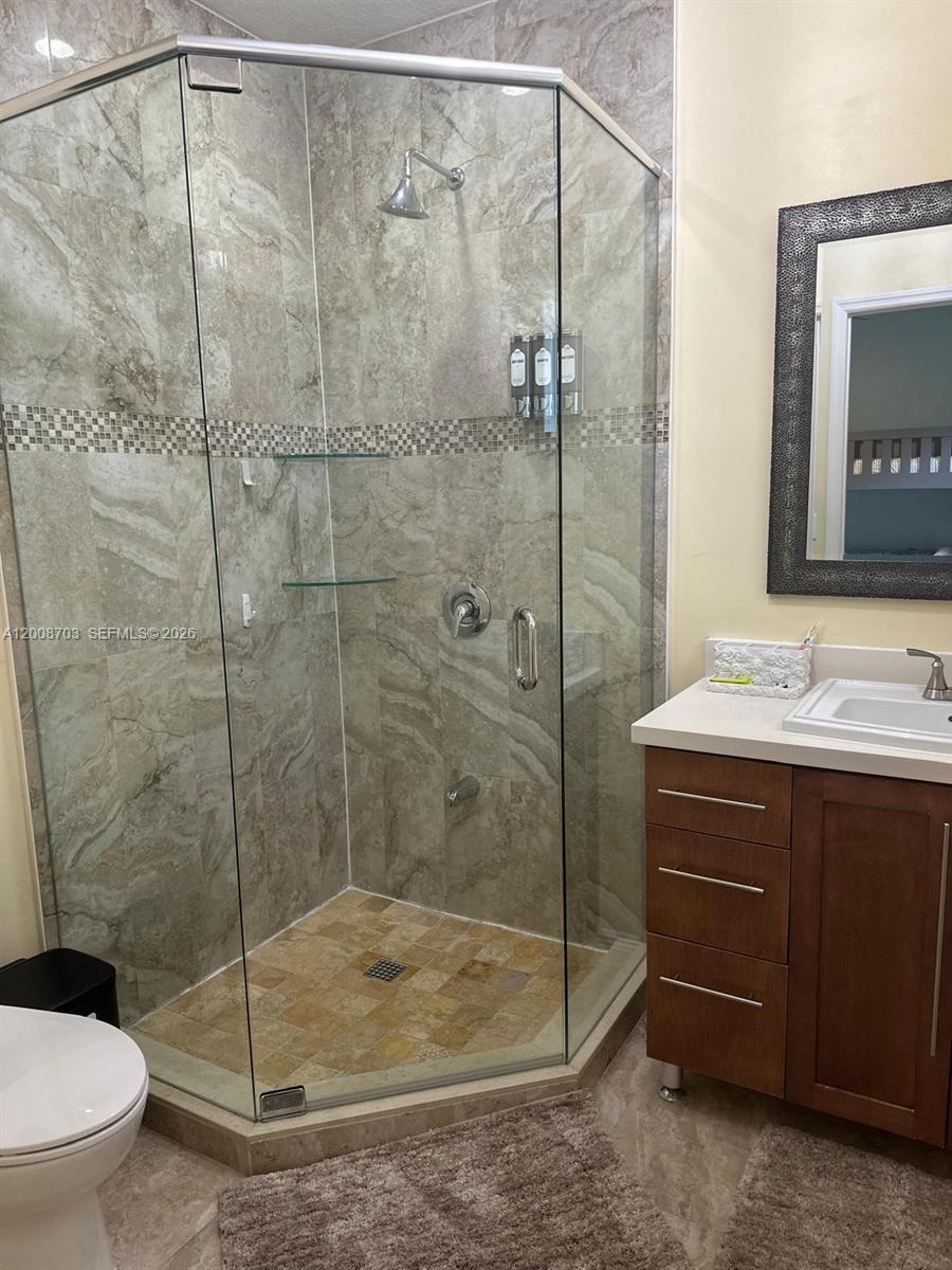 1019 Snapper Lane Key Largo, FL 33037 - Photo 33 of 37 a bathroom with a shower sink mirror and toilet