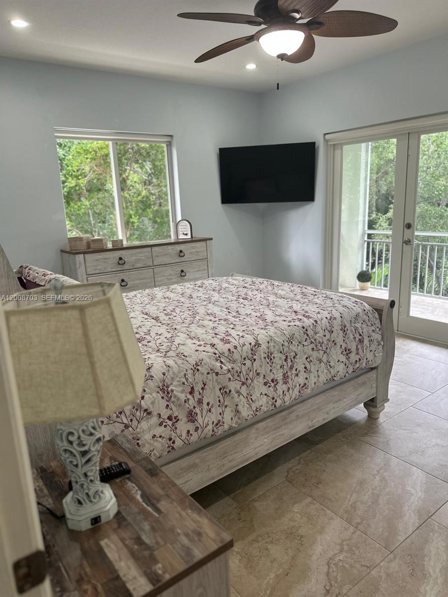 1019 Snapper Lane Key Largo, FL 33037 - Photo 36 of 37 a bedroom with a bed and glass window