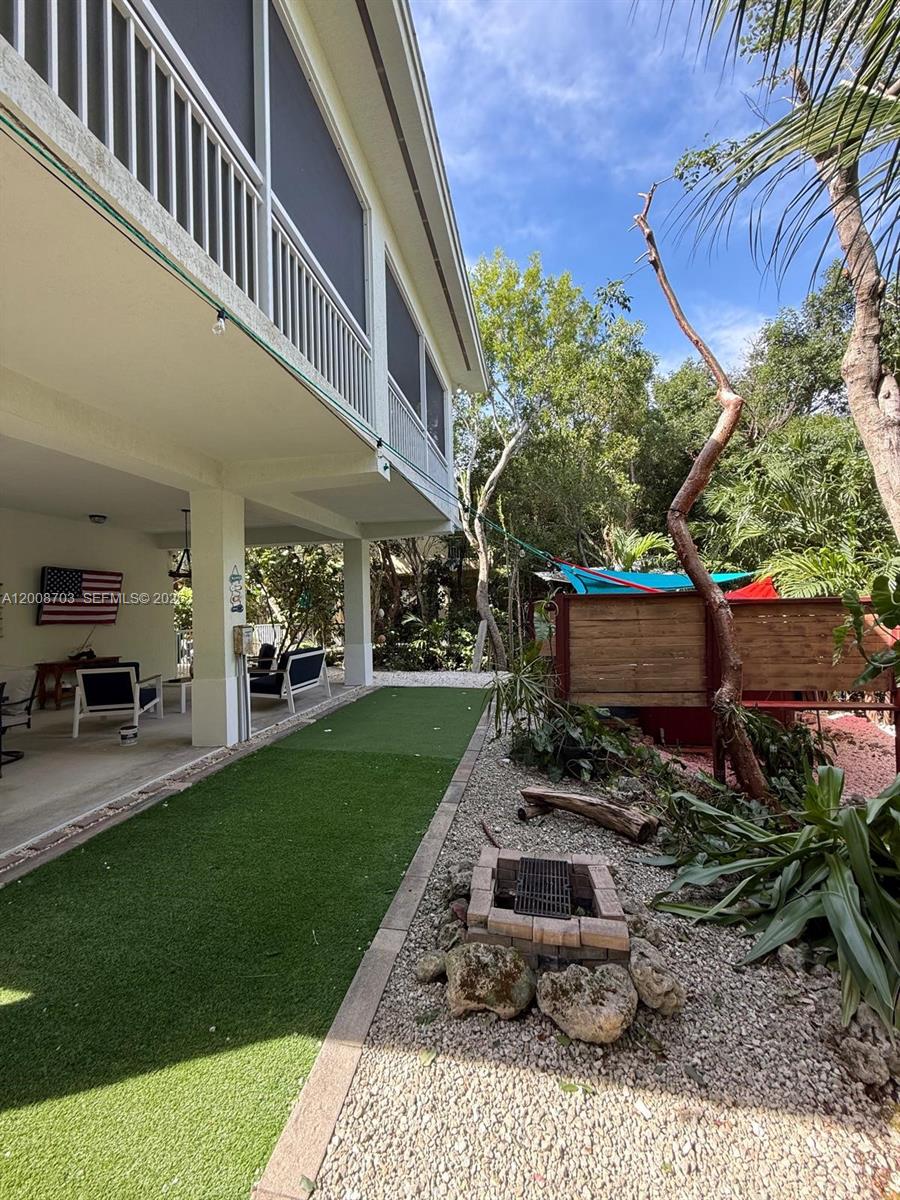 1019 Snapper Lane Key Largo, FL 33037 - Photo 7 of 37 a backyard of a house with table and chairs