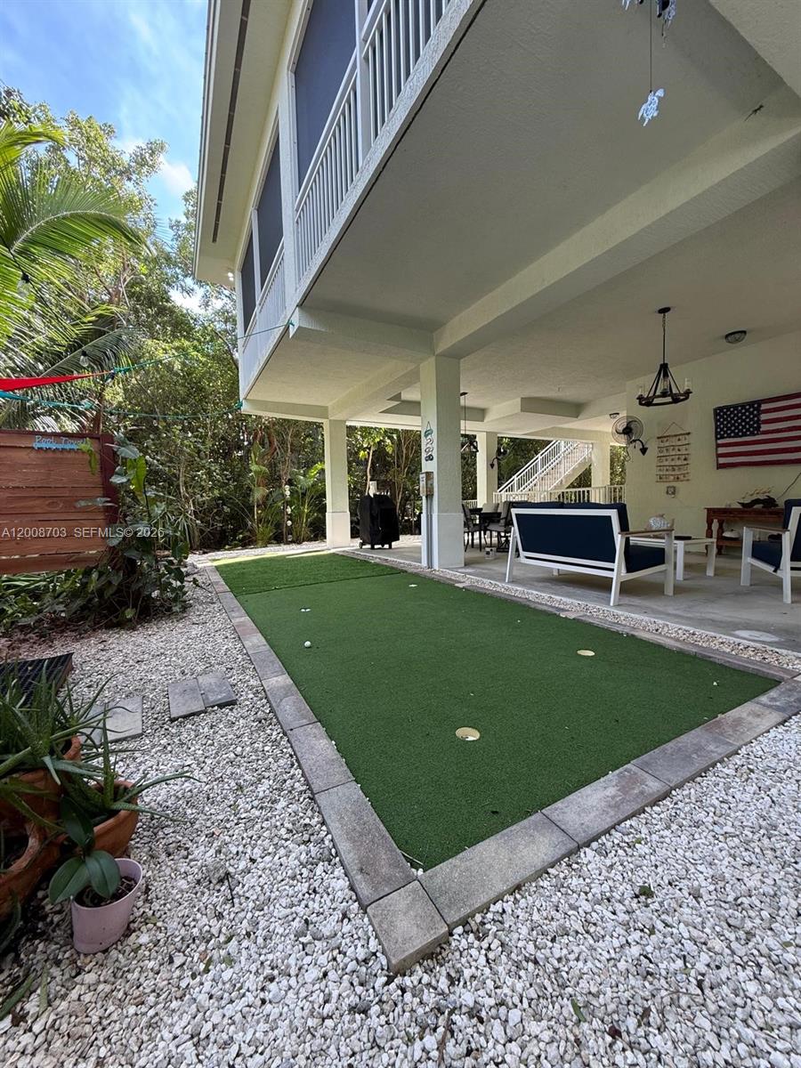 1019 Snapper Lane Key Largo, FL 33037 - Photo 9 of 37 a swimming pool with barbeque oven and outdoor seating