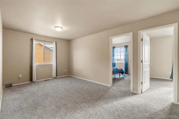an empty room with windows and closet