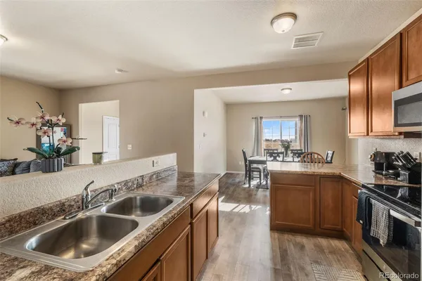 a kitchen with a sink stove top oven and refrigerator