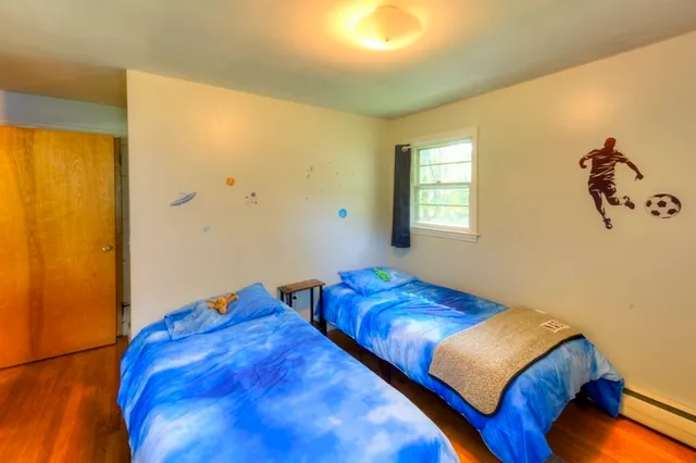 a bedroom with two beds and painted walls