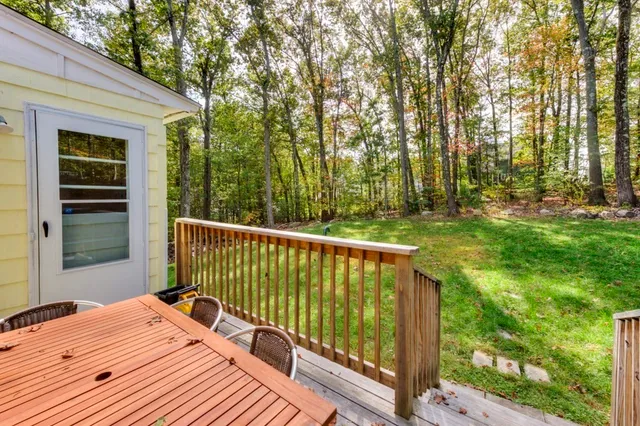 a view of a balcony with wooden floor and fence