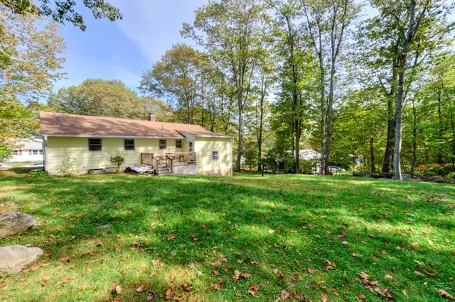 a view of an house with backyard space and balcony
