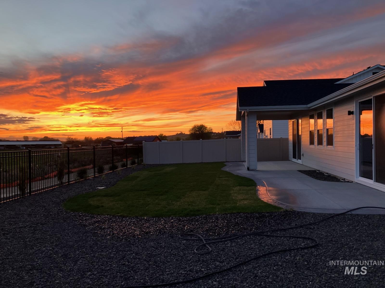 12557 West Wayfaring Drive Star, ID 83669 - Photo 6 of 25 Yard at dusk featuring a patio area and a fenced backyard
