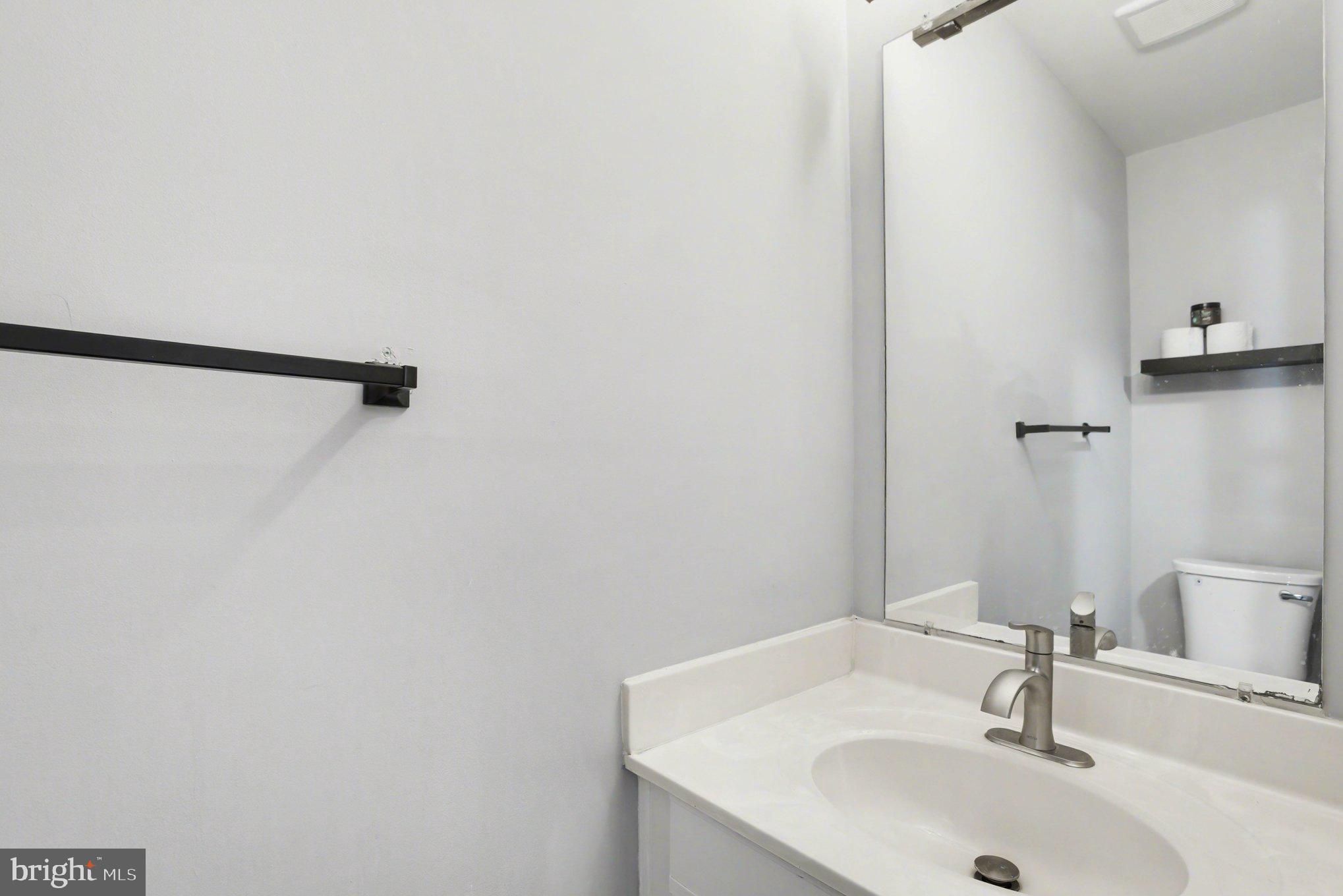 216 Scott Street Baltimore, MD 21230 - Photo 12 of 27 a bathroom with a sink and a mirror