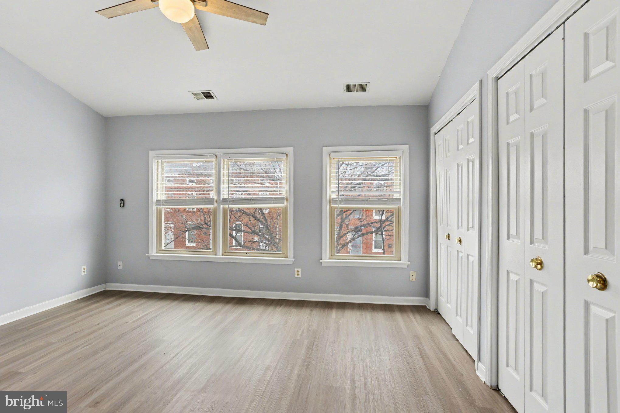 216 Scott Street Baltimore, MD 21230 - Photo 14 of 27 an empty room with wooden floor and windows