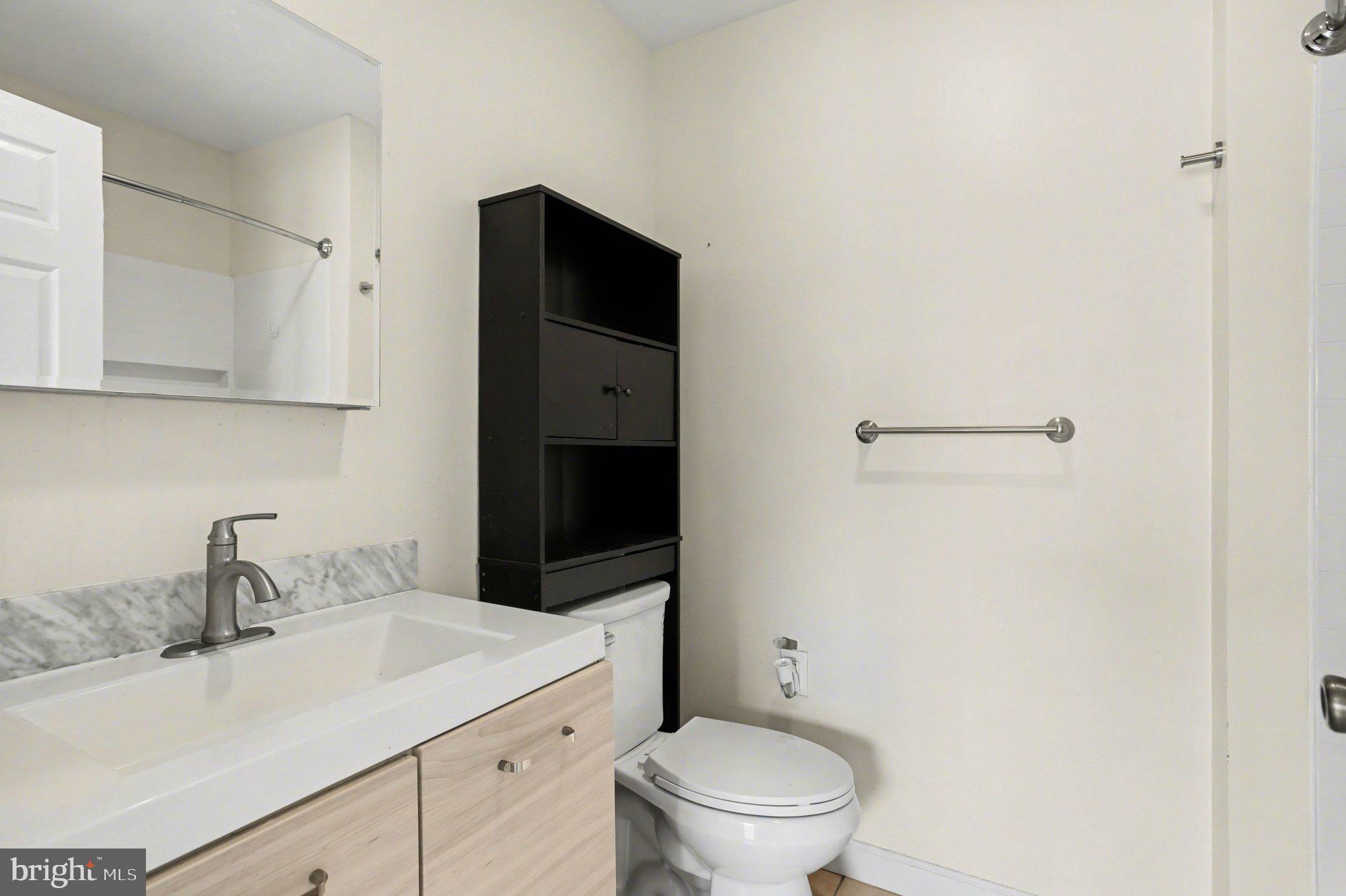 216 Scott Street Baltimore, MD 21230 - Photo 16 of 27 a bathroom with a sink toilet and vanity