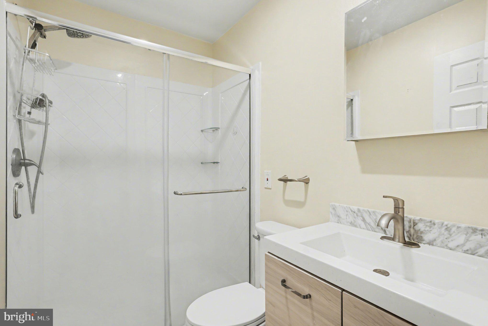 216 Scott Street Baltimore, MD 21230 - Photo 18 of 27 a bathroom with a sink toilet and shower