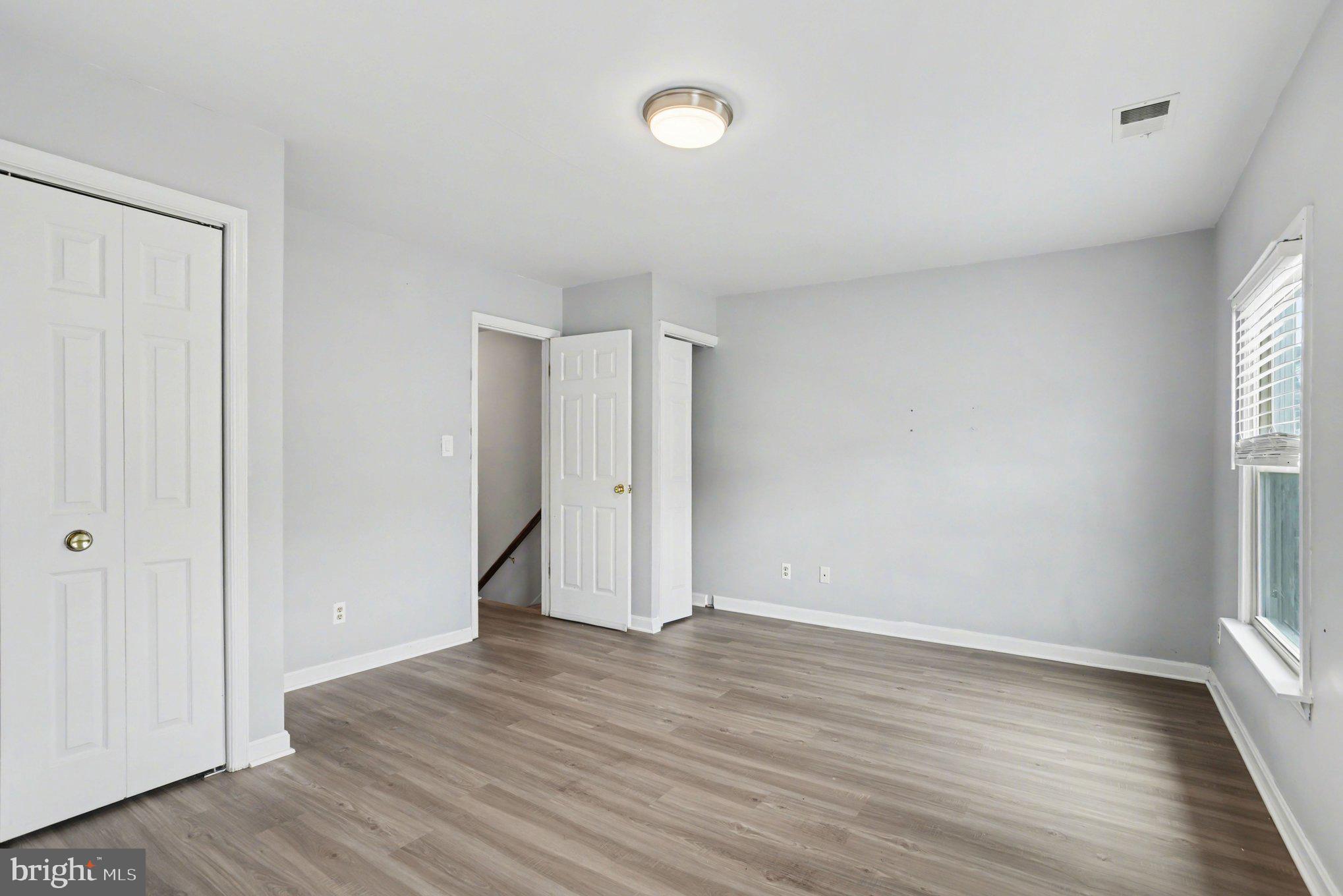 216 Scott Street Baltimore, MD 21230 - Photo 19 of 27 an empty room with wooden floor and windows