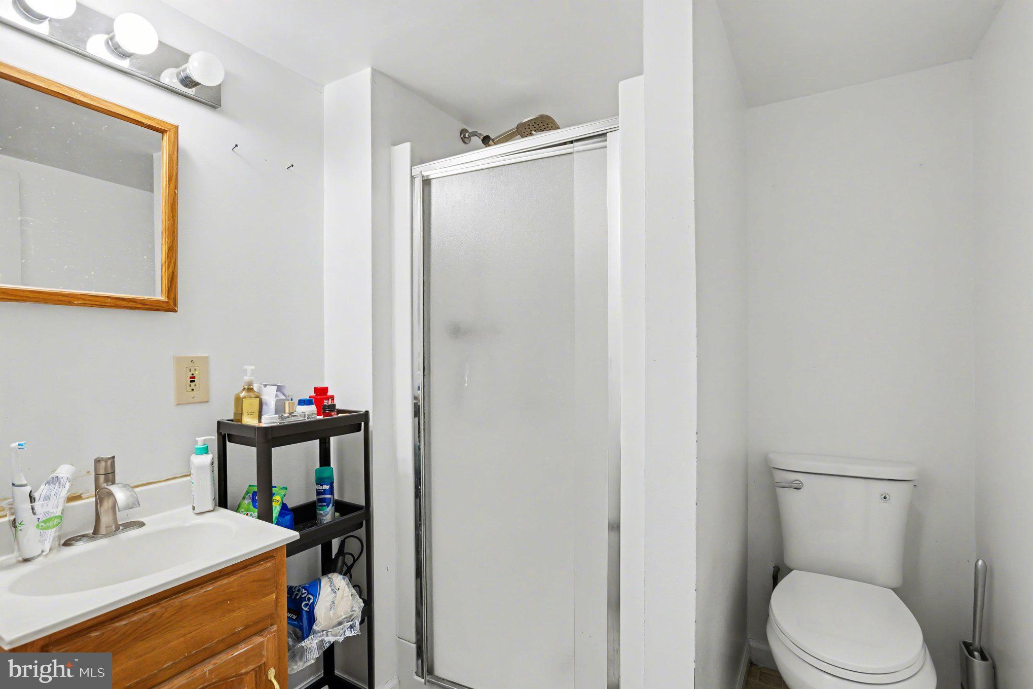 216 Scott Street Baltimore, MD 21230 - Photo 24 of 27 a bathroom with a sink vanity mirror and toilet