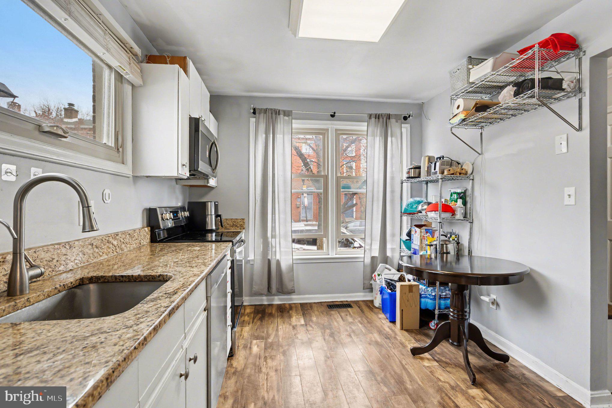 216 Scott Street Baltimore, MD 21230 - Photo 9 of 27 a kitchen with a refrigerator a sink dishwasher and a stove top oven