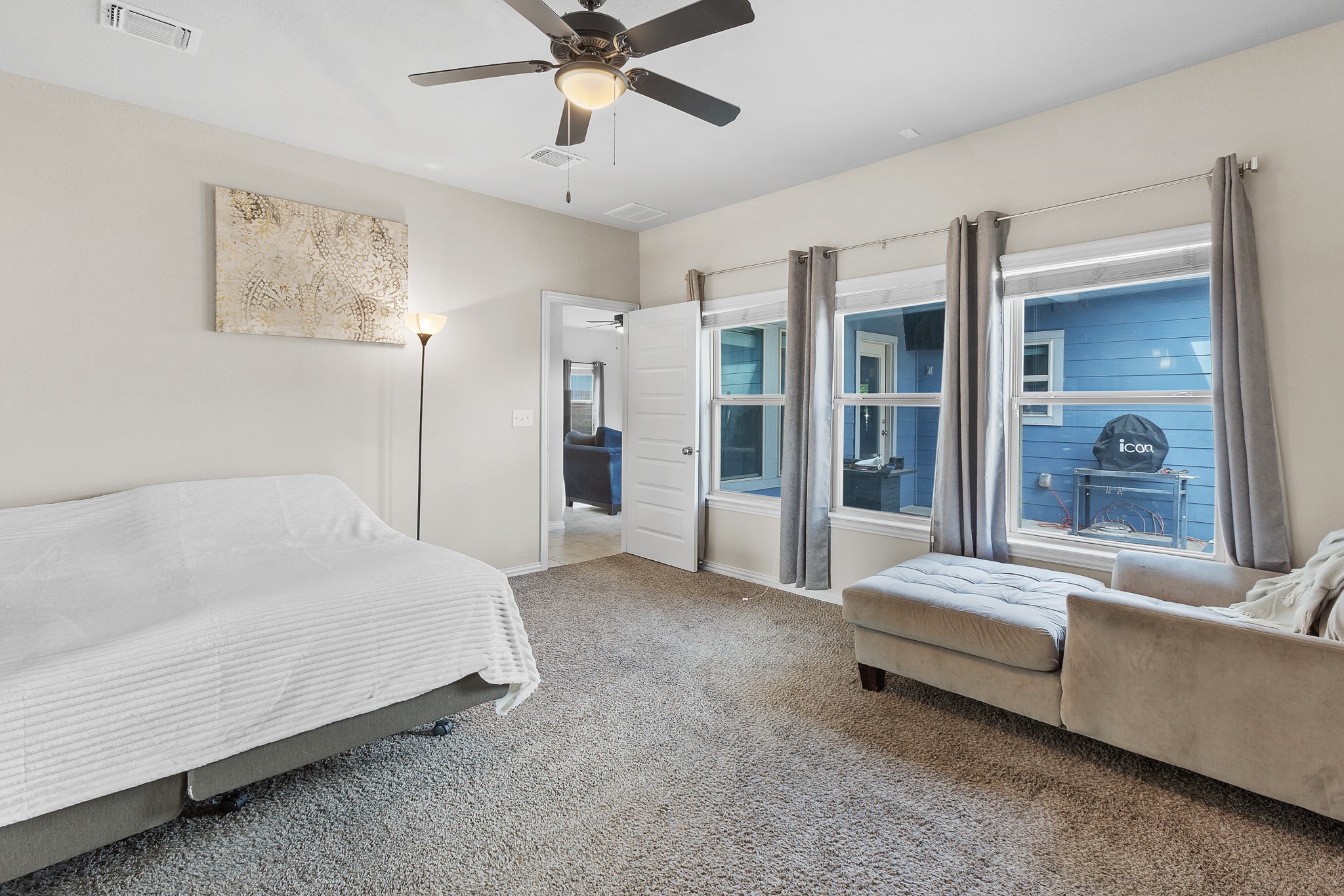 8709 Slater Drive Austin, TX 78747 - Photo 16 of 36 a spacious bedroom with a bed and a chandelier