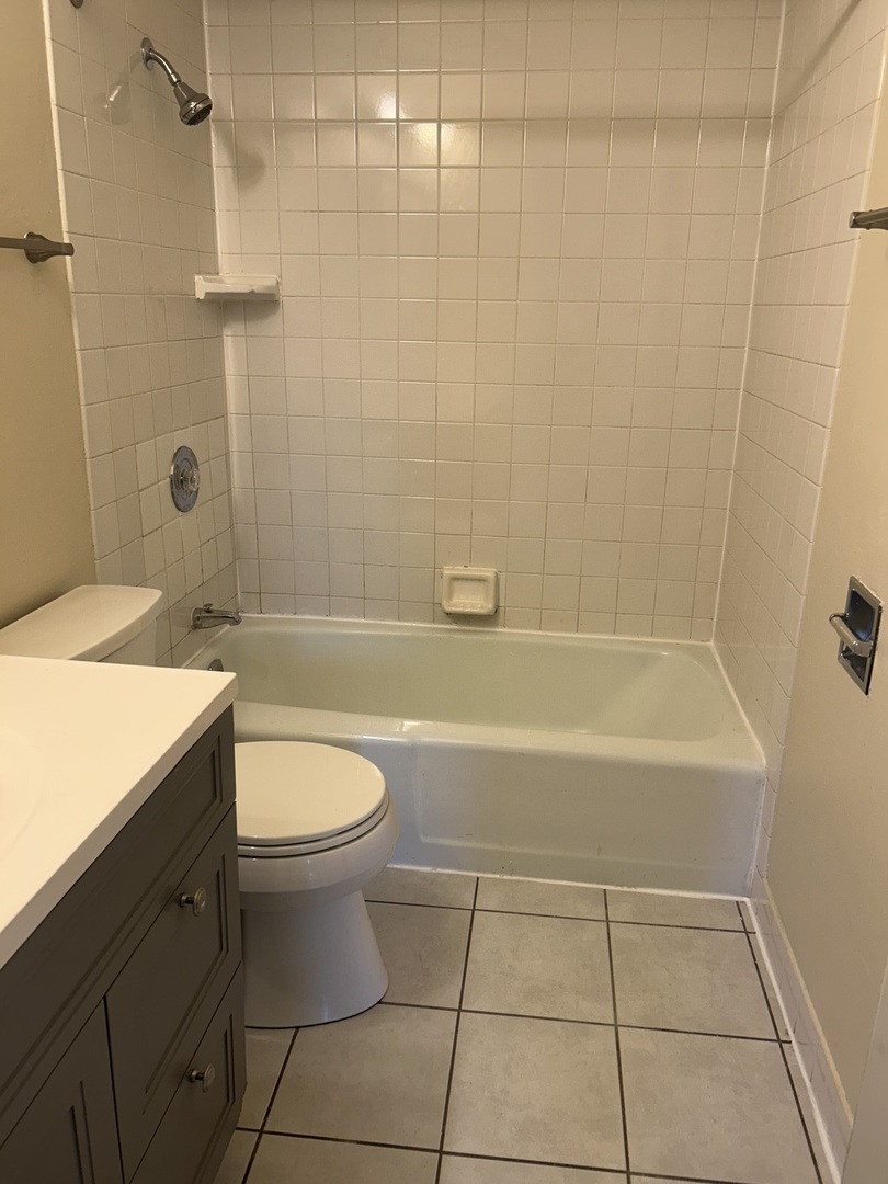 12620 South Alpine Drive, Unit 4 Alsip, IL 60803 - Photo 11 of 13 a bathroom with a sink a toilet and shower