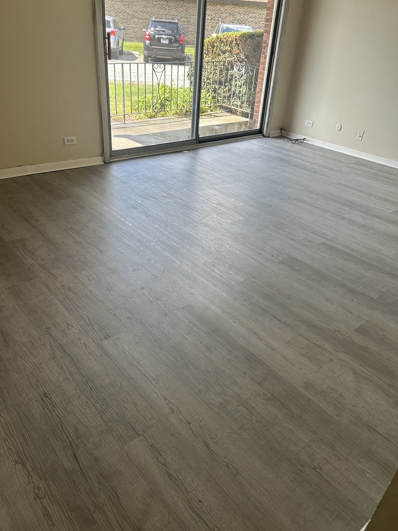 12620 South Alpine Drive, Unit 4 Alsip, IL 60803 - Photo 13 of 13 a view of an empty room with wooden floor and a window