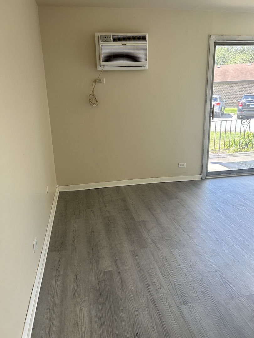 12620 South Alpine Drive, Unit 4 Alsip, IL 60803 - Photo 9 of 13 a view of a room with wooden floor and a window