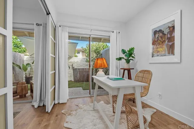 a dining room with furniture and wooden floor