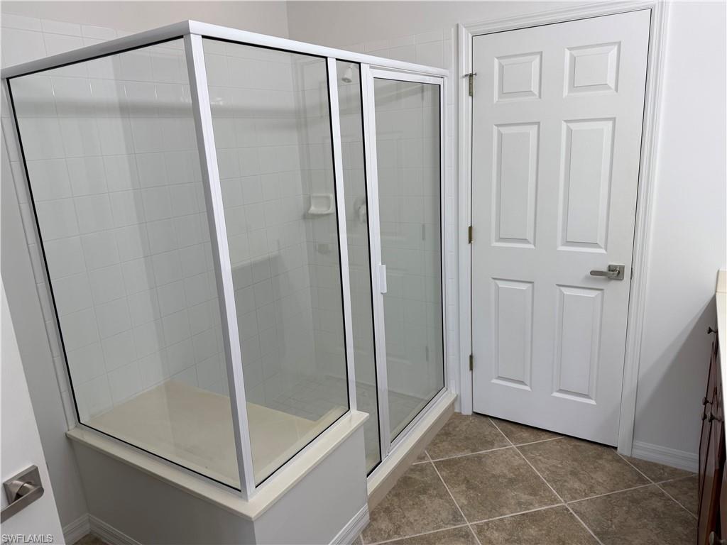 1345 Henley Street, Unit 705 Naples, FL 34105 - Photo 16 of 26 a bathroom with a glass door shower