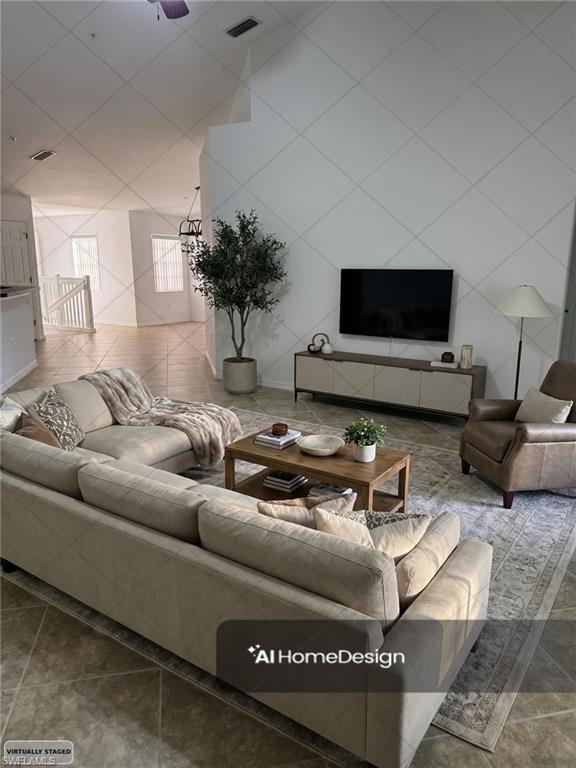 1345 Henley Street, Unit 705 Naples, FL 34105 - Photo 4 of 26 a living room with furniture and a flat screen tv