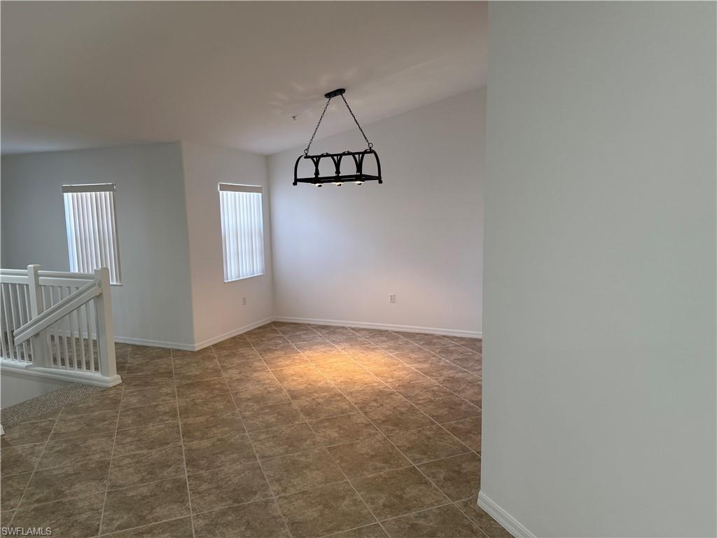 1345 Henley Street, Unit 705 Naples, FL 34105 - Photo 6 of 16 an empty room with windows and ceiling fan view